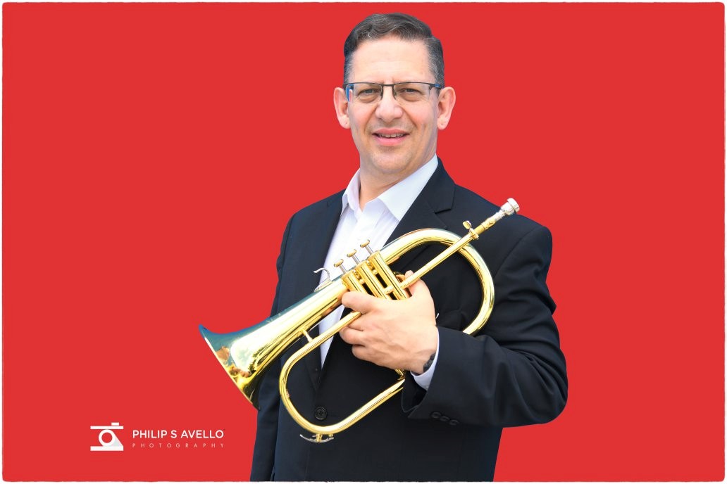Dr. Jack Wengrosky holding a trumpet